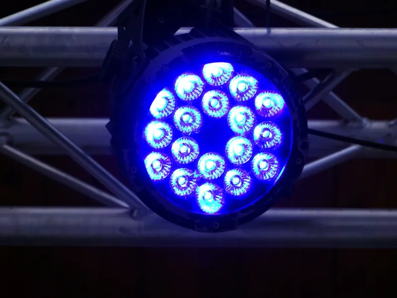 Refletor par LED aceso em azul, preso numa treliça